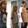 Five young students lined up in a row presenting a scene for actors boot camp