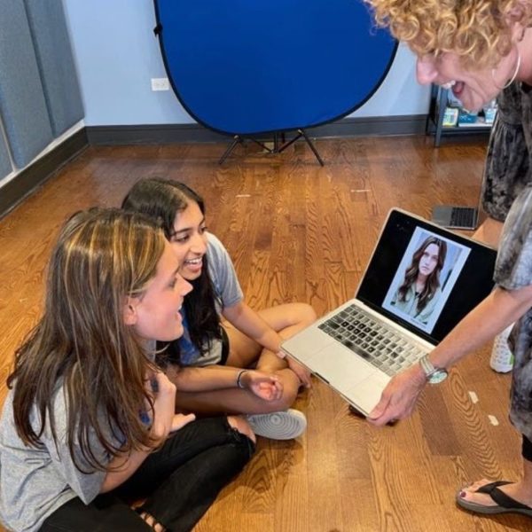 ATC founder, Carole Dibo, showing a teen student a picture of their headshot taken during psi
